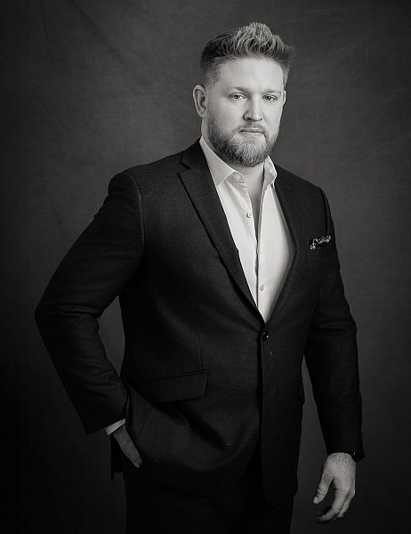 Black and white photograph of a st. louis professional executive man in a black suit and white shirt. 