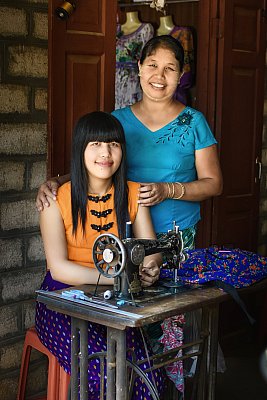 Two Myanmar tailors in their shop in Myanmar. Color photograph. 