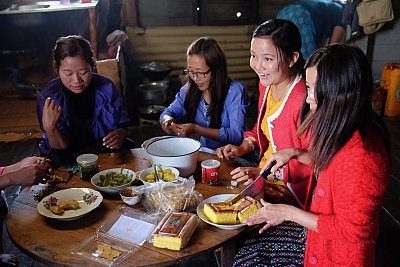 Color photograph of young women preparing for Afternoon tea in Chin State, Myanmar. 