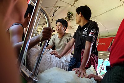 Photograph of young men taking their vegetables to market on the Circle Train in Yangon, Myanmar. 